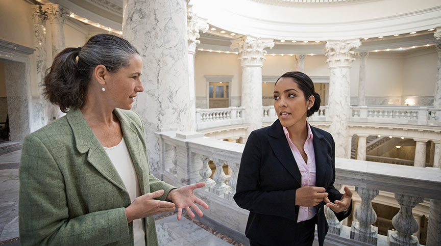 Two women discussing our government leadership training programs.