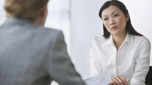 image of 2 coworkers talking, representing a tough conversation dealing with a difficult employee