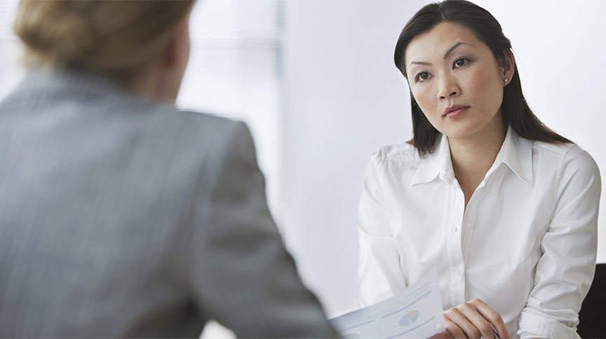 image of 2 coworkers talking, representing a tough conversation dealing with a difficult employee