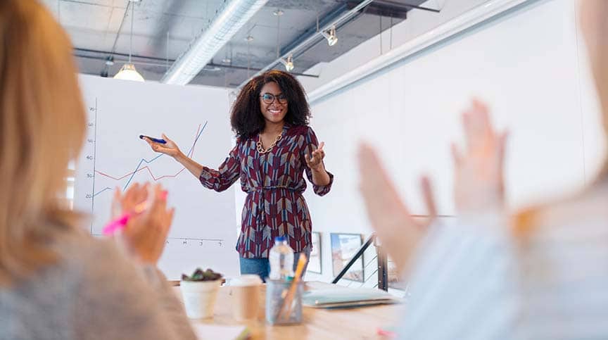 woman leading a meeting and modeling self care showing how to reimagine the servant leadership model