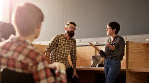 woman discussing effective influencing and being an influential leader with a colleague at work