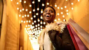 Woman smiling as she learns how to Maximize Joy and 4 Savoring Strategies for the Holidays and Beyond